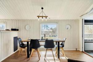 a kitchen and dining room with a table and chairs at BL1546-Saltum-Stenrev-6 in Saltum