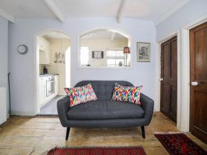 a living room with a couch and a kitchen at Kernyck in Port Isaac +15 photos