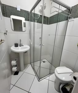 a white bathroom with a sink and a toilet at Kitnet Studio Apartamento Privativo Jundiaí 06 in Jundiaí
