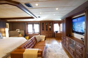 a bedroom with a couch and a large screen tv at iRama Luxury Superyacht 6 Cabins & Hot Tub & Water Toys in Cannes +34 photos