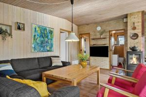 a living room with a couch and a table at BL1275-Blokhus-Pirupshvarrevej-17 in Blokhus