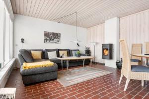 a living room with a couch and a table at BL1397-Pandrup-Rodhus-Klitvej-363 in Pandrup