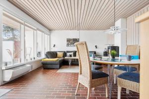 a kitchen and living room with a table and chairs at BL1397-Pandrup-Rodhus-Klitvej-363 in Pandrup +19 photos