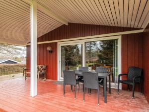 a patio with a table and chairs on a deck at 6 person holiday home in Fårvang in Fårvang