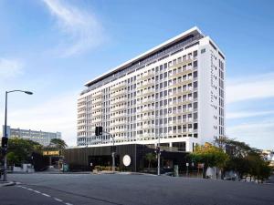 a large white building on the corner of a street at Premium City Escape-Stunning Skyline Views in Brisbane