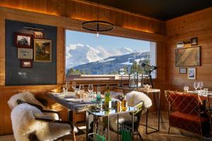 a restaurant with a view of a mountain at Chalet Alpen Valley, Mont-Blanc in Combloux