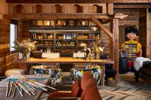 a living room with a wooden table and chairs at Chalet Alpen Valley, Mont-Blanc in Combloux +61 photos