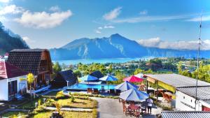 an aerial view of a resort with a lake and mountains at Bali Cottages Lake View in Kintamani