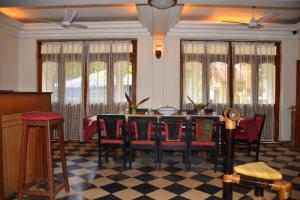 a dining room with a table and chairs at Hotel Kismat Mahal in Calangute