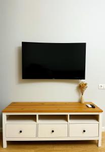 a flat screen tv on a white wall at Современная и уютная квартира в районе ЭКСПО, ТРЦ Mega Silk Way in Astana