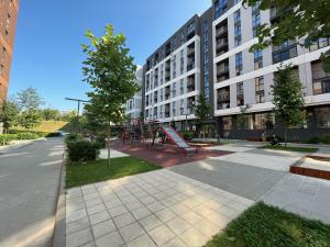 a playground in front of a building at Green HOUSE апартаменти вул Зелена 204 новобуд in Lviv