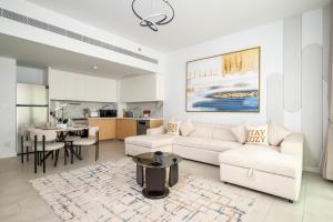 a living room with a couch and a table at Beach Please in Dubai