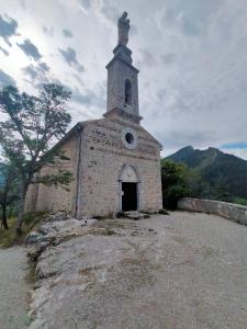 an old brick church on top of a hill at CHARMING studio proche centre in Castellane