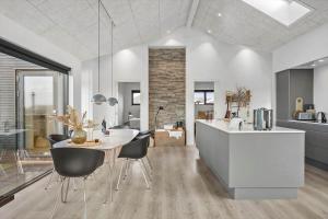 una cucina e una sala da pranzo con tavolo e sedie di BL1427-Blokhus-Ovesensvej-9 a Blokhus