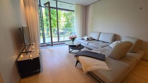 a living room with a couch and a table at First Line - Dzintaru prospekts Apartment in Jūrmala