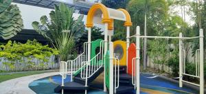 a playground in a backyard with a play structure at Chic and Affordable Studio in Davao City