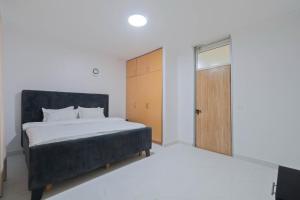 a bedroom with a bed and a wooden door at Blue Ivy in Lagos +7 photos