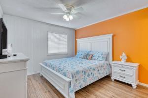 a bedroom with a bed and a ceiling fan at 2 Bedroom Oceanview Condo at Sea Cabin! Sleeps 5! in Myrtle Beach +11 photos