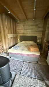 a bedroom with a bed in a wooden room at Comfort Family UZH in Uzhhorod