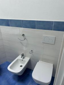 a bathroom with a toilet and a sink at Dimora del Verde in Ischia +19 photos