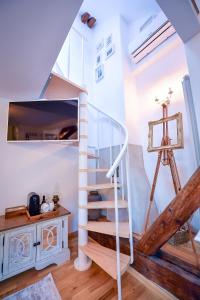 a spiral staircase in a room with a tripod at Casa Baritiu M in Braşov