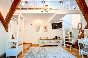 a living room with a staircase and a table at Casa Baritiu M in Braşov +27 photos