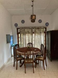 a dining room with a table and chairs at Ameeila villa in Kandy