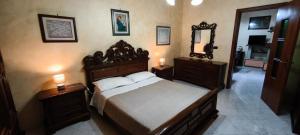 a bedroom with a bed with two night stands and a mirror at Casa Antonietta in Aradeo