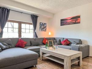 a living room with a couch and a coffee table at Apartment Holiday-Home Nr 1 am Bostalsee by Interhome in Steinberg-Deckenhardt +21 photos