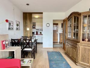 a living room with a table and a dining room at Apartment App- 1406 - EX-Kurhotel Schluchsee by Interhome in Schluchsee