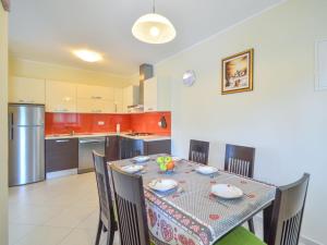 a dining room with a table and chairs in a kitchen at Apartment Marijo by Interhome in Matulji