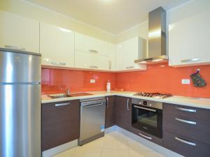 a kitchen with wooden cabinets and a stainless steel refrigerator at Apartment Marijo by Interhome in Matulji +16 photos
