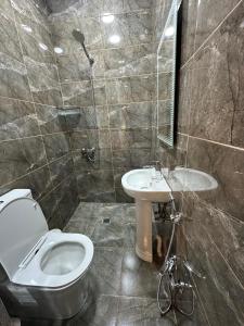 a bathroom with a toilet and a sink at Resort Hotel Baku in Baku