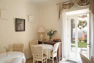 a dining room with a table and chairs at Siora Vittoria Boutique Hotel in Corfu