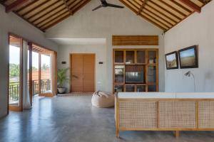 a living room with a couch and a table at ZIN Berawa Villas & Bungalows in Canggu