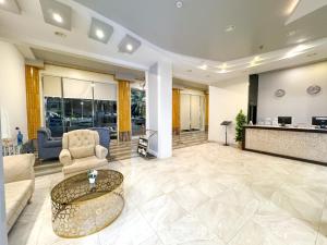 a living room with a couch and a table at Masaf apartment in Al Mithnab +6 photos