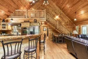 eine Küche und Bar in einer Blockhütte in der Unterkunft DANCING BEARS CABIN - Secluded 3-Bedroom, 3.5-Bath Luxury Cabin with Hot Tub in Mineral Bluff