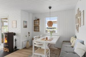 a living room with a table and a couch at BL1020-Pandrup-Hunetorp-Klitvej-257 in Pandrup +20 photos