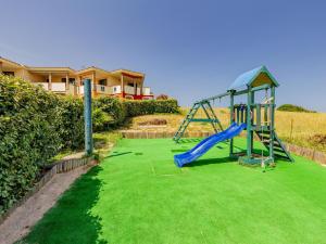 a playground with a slide in a yard at Residenza Le Farfalle in Tergu