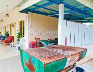a house with a colorful table on a patio at Puteri Duyong Homestay in Malacca