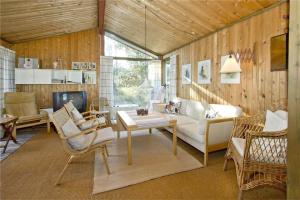 a living room with a couch and a table and chairs at BL363-Saltum-Nyborgvej-4 in Saltum