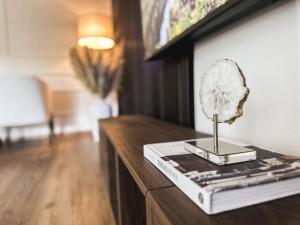 a table with a book and a mirror on it at Apartment Am Obersalzberg by Interhome in Berchtesgaden +31 photos