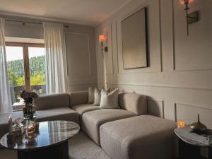 a living room with a couch and a table at Apartment Am Obersalzberg by Interhome in Berchtesgaden