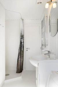 a white bathroom with a sink and a shower at BL1729-Blokhus-Jens-Baerentsvej-36 in Blokhus +25 photos