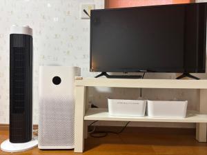a desk with a computer and a speaker and a television at Chiba - House - Vacation STAY 34595v in Chiba
