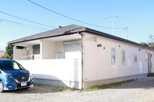 a car parked in front of a white building at Chiba - House - Vacation STAY 34595v in Chiba