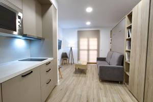 a kitchen and living room with a couch and a table at Hurtado de Mendoza by Cuencaloft in Cuenca