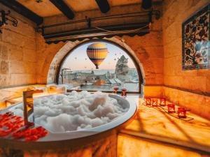 a bath tub filled with foam in a room with a balloon at Erenbey Cave Hotel Adults Only Plus 12 in Goreme