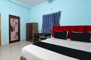 Ένα ή περισσότερα κρεβάτια σε δωμάτιο στο Hotel O AMULYA AASHIYANA