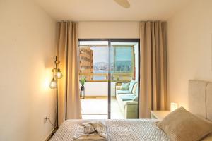 a bedroom with a bed and a view of a balcony at Oasis Levante Beach Benidorm - Trinisol II in Benidorm +41 photos